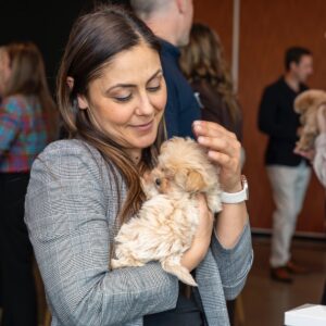 Attendee holding a puppy during the PetAds Unleashed networking session.