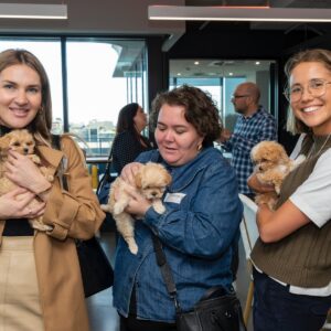Attendees enjoying puppy cuddles during the PetAds Unleashed event in Melbourne.