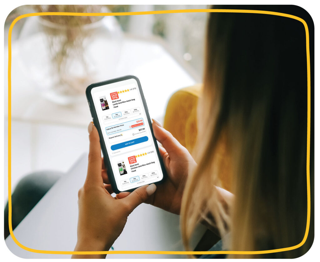 Pet parent browsing sponsored product ads in Petbarn search results on a mobile phone